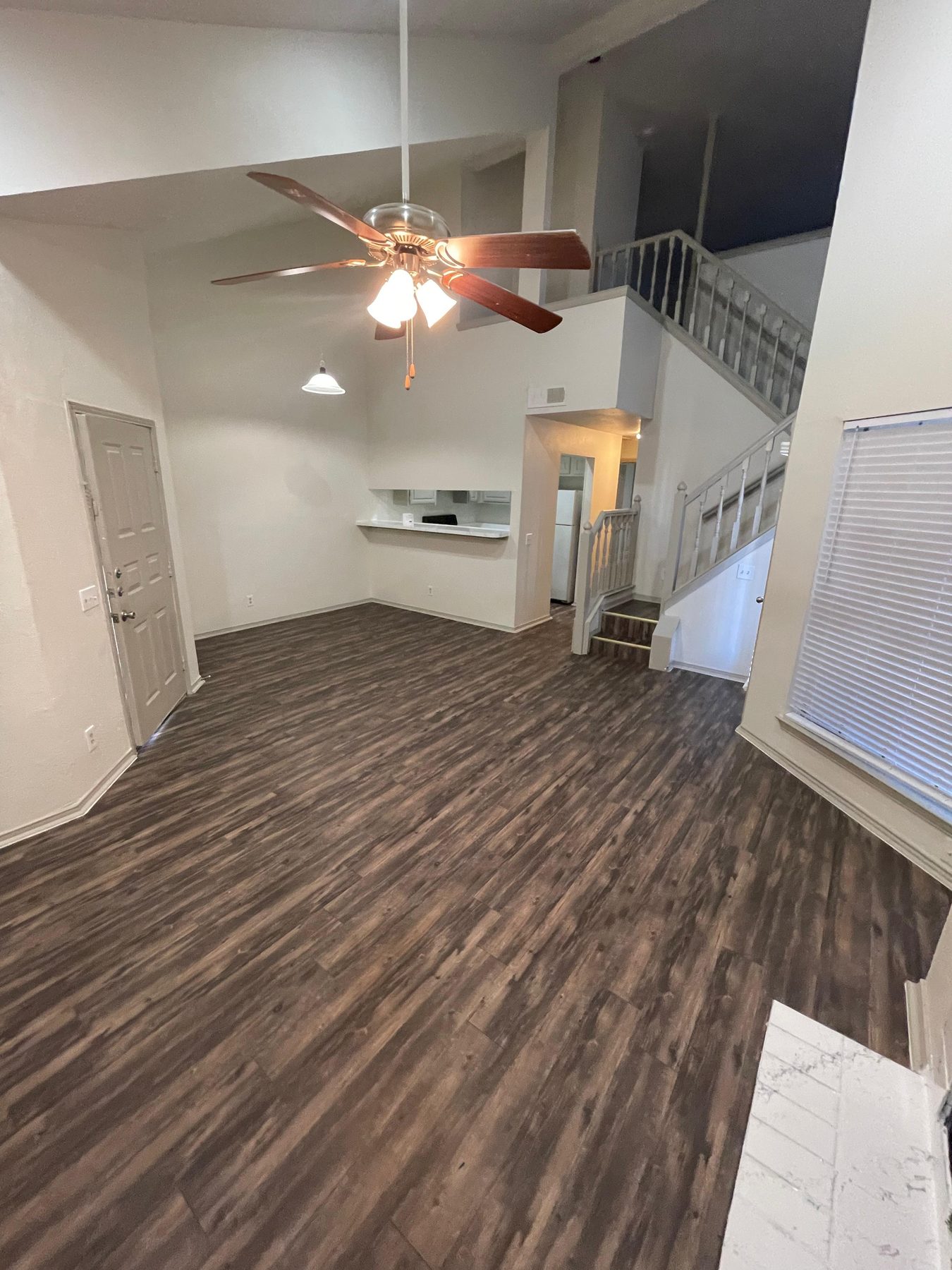 Living room with fireplace and warm wood-look flooring
