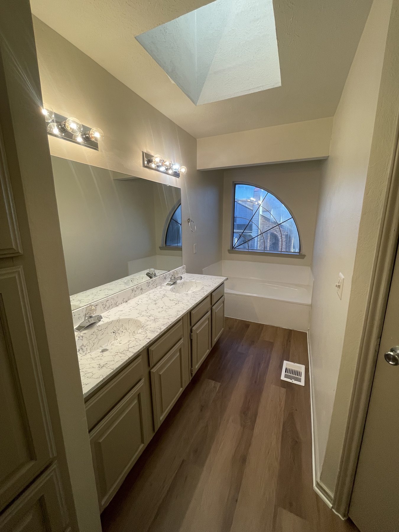 Open staircase rising to a skylit two-story living space