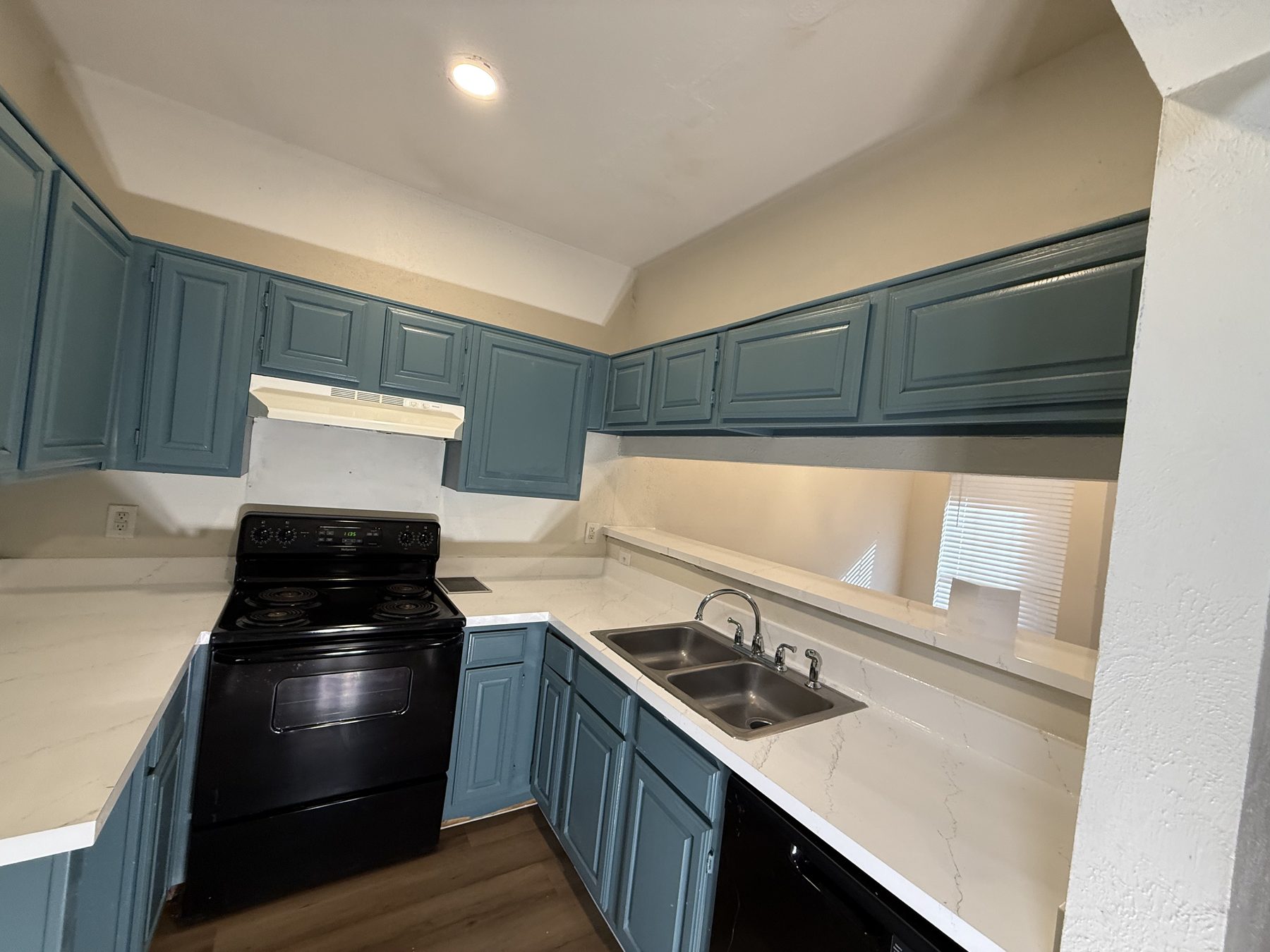Updated kitchen with dark cabinetry and stainless appliances