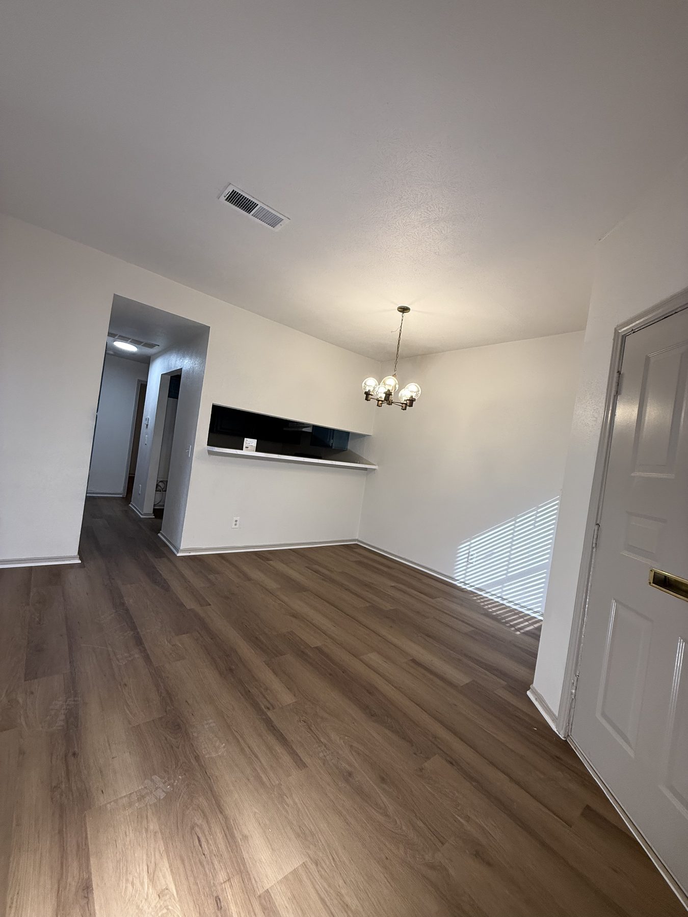 Open living and dining area with wood-look floors